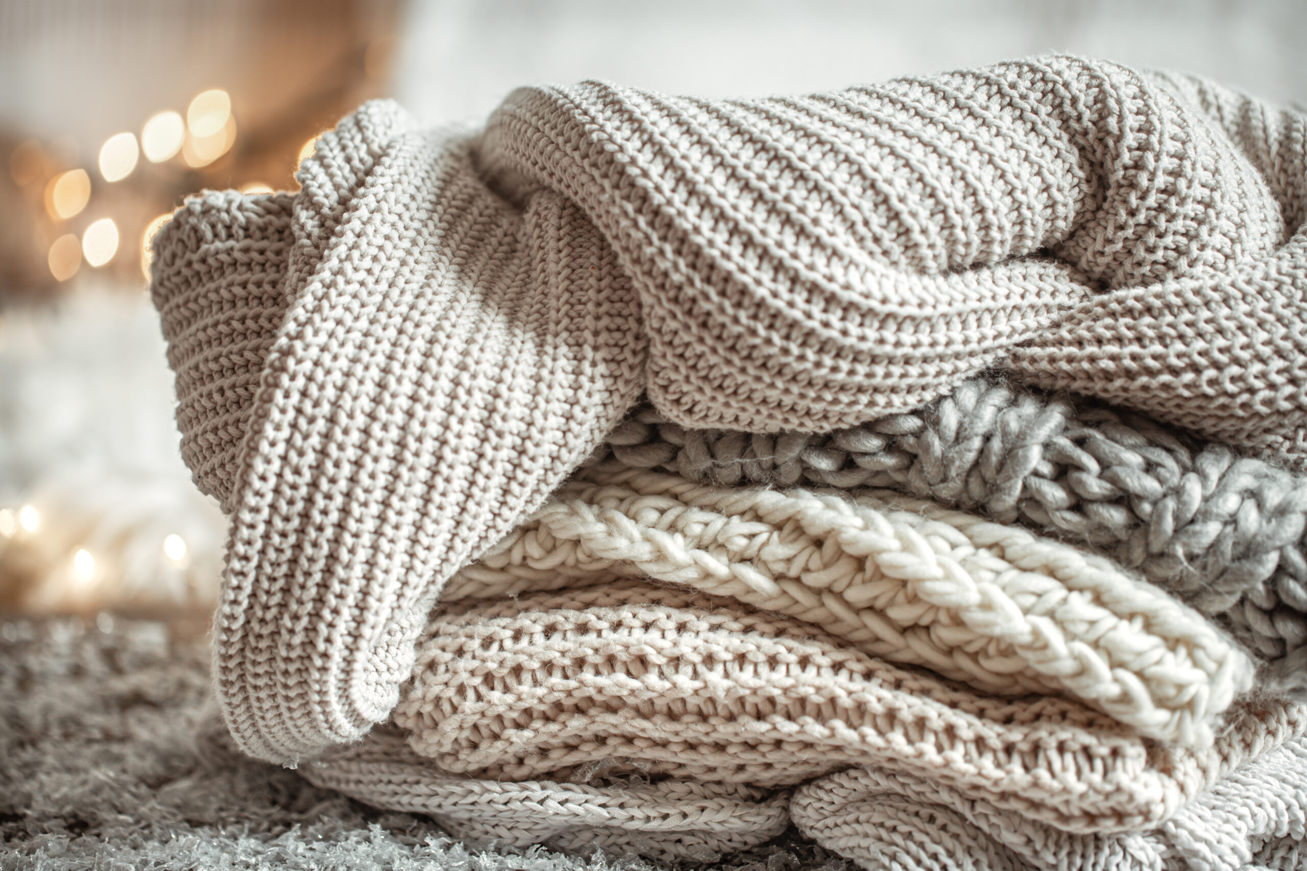 winter background with knitted elements on a blurred background close up.